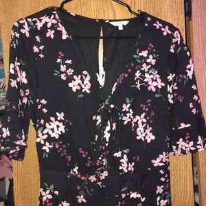 Romper , it’s black with pink flowers. Never worn